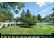 Expansive backyard featuring a well-maintained lawn, mature trees, and a white fence at 37 E Waterbury Rd, Indianapolis, IN 46227