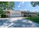 Charming single-story home with a manicured lawn, a long driveway, and an attached garage at 37 E Waterbury Rd, Indianapolis, IN 46227