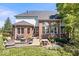 Brick patio with an outdoor kitchen, fireplace, and seating area, perfect for entertaining at 3711 Pete Dye Blvd, Carmel, IN 46033
