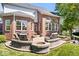 Beautiful backyard patio featuring a cozy fire pit, ample seating, and a lush green lawn at 3711 Pete Dye Blvd, Carmel, IN 46033