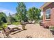 The stone patio features outdoor seating and dining areas for relaxation and entertaining friends at 3711 Pete Dye Blvd, Carmel, IN 46033