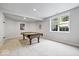 Finished basement with a well-lit billiard area and a large window for natural light at 3711 Pete Dye Blvd, Carmel, IN 46033