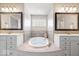 Luxurious bathroom featuring a soaking tub, double vanities and decorative tile at 3711 Pete Dye Blvd, Carmel, IN 46033