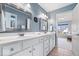 Bright bathroom with double sinks, white cabinets, and modern lighting fixtures at 3711 Pete Dye Blvd, Carmel, IN 46033