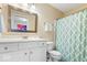 Well-lit bathroom featuring a vanity with a modern sink and a patterned shower curtain at 3711 Pete Dye Blvd, Carmel, IN 46033