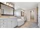 Elegant bathroom with soaking tub, dual vanities, and neutral color palette at 3711 Pete Dye Blvd, Carmel, IN 46033
