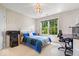 Cozy bedroom with a large window, desk, and unique lighting fixture at 3711 Pete Dye Blvd, Carmel, IN 46033