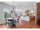Dining area flows into kitchen with hardwood floors and lots of natural light at 3711 Pete Dye Blvd, Carmel, IN 46033