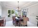 Formal dining room features large windows, elegant chandelier, and classic trim work at 3711 Pete Dye Blvd, Carmel, IN 46033