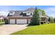 Lovely two-story home featuring an attached three-car garage and a lush green lawn at 3711 Pete Dye Blvd, Carmel, IN 46033