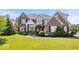 Beautiful two-story brick home with well-manicured lawn and professional landscaping at 3711 Pete Dye Blvd, Carmel, IN 46033