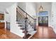 Grand foyer with hardwood floors, staircase, and view of the front door at 3711 Pete Dye Blvd, Carmel, IN 46033