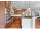 Gourmet kitchen with granite countertops, stainless steel appliances, and hardwood floors at 3711 Pete Dye Blvd, Carmel, IN 46033