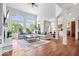 Bright living room featuring soaring ceilings, large windows, fireplace, and hardwood floors at 3711 Pete Dye Blvd, Carmel, IN 46033