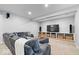 Spacious living room featuring a comfortable sectional sofa and a large built-in entertainment center at 3711 Pete Dye Blvd, Carmel, IN 46033