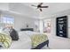 Spacious main bedroom with tray ceiling, ceiling fan and ensuite bathroom access at 3711 Pete Dye Blvd, Carmel, IN 46033