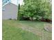 Spacious backyard featuring green grass and mature trees and side view of home at 3903 Junco Cir, Indianapolis, IN 46228