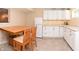Basement kitchenette featuring white cabinets, granite countertops, and a wooden dining table at 3903 Junco Cir, Indianapolis, IN 46228