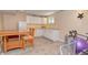 View of the basement kitchenette with white cabinetry and a wooden dining table set at 3903 Junco Cir, Indianapolis, IN 46228