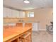 Basement kitchenette with white cabinets, stone counters and a wooden table and chairs at 3903 Junco Cir, Indianapolis, IN 46228