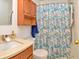 Classic bathroom with a wooden vanity, and a shower with a decorative curtain at 3903 Junco Cir, Indianapolis, IN 46228