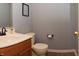 Cozy bathroom featuring a traditional vanity, toilet, and decor at 3903 Junco Cir, Indianapolis, IN 46228