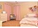 Charming bedroom with pink accents, a cozy chair, and a comfortable bed at 3903 Junco Cir, Indianapolis, IN 46228