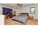 Serene bedroom with neutral carpet, a ceiling fan, and a cozy sitting area with a desk at 3903 Junco Cir, Indianapolis, IN 46228
