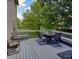 Spacious wooden deck with outdoor dining set and additional seating overlooking green yard at 3903 Junco Cir, Indianapolis, IN 46228