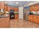Well-appointed kitchen with stainless steel appliances, oak cabinets, and modern countertops at 3903 Junco Cir, Indianapolis, IN 46228