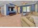 Open-concept living room with neutral carpet, blue walls, staircase, and lots of natural light at 3903 Junco Cir, Indianapolis, IN 46228