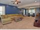 Spacious living room with plush sofa, ceiling fans, and natural light at 3903 Junco Cir, Indianapolis, IN 46228