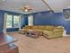 Spacious living room featuring blue walls, neutral carpet, and bright natural light at 3903 Junco Cir, Indianapolis, IN 46228