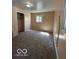 Bedroom featuring neutral carpet, a small window, and light tan walls at 4014 Arquette Dr, Indianapolis, IN 46235