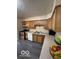 Charming kitchen with neutral counters, wooden cabinets, stainless steel oven, dishwasher, and luxury vinyl plank flooring at 4014 Arquette Dr, Indianapolis, IN 46235