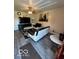 Comfortable living room featuring modern furniture, a ceiling fan, and a large flat screen television at 4014 Arquette Dr, Indianapolis, IN 46235