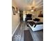 Inviting living room area with a TV, fan, artwork, and light-colored walls and luxury vinyl plank flooring at 4014 Arquette Dr, Indianapolis, IN 46235