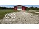 Rustic barn featuring a weathered exterior and functional design, sitting on a gravel driveway at 4680 Cartersburg Rd, Plainfield, IN 46168
