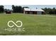Classic barn with a gambrel roof, standing proudly in a wide-open grassy field at 4680 Cartersburg Rd, Plainfield, IN 46168