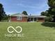 Charming brick ranch home with well-maintained lawn and mature trees on a sunny day at 4680 Cartersburg Rd, Plainfield, IN 46168