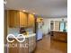 Spacious kitchen with wood floors, light wood cabinetry, and a center island at 4680 Cartersburg Rd, Plainfield, IN 46168