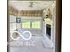 Bright sunroom with a cozy fireplace, built-in shelves, and large windows overlooking the backyard at 4680 Cartersburg Rd, Plainfield, IN 46168