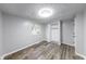 Well-lit bedroom features a window and closet, complemented by sleek flooring at 5512 Lunsford Dr, Indianapolis, IN 46237