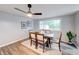 Dining area featuring a modern light fixture, stylish decor, and a large window with a view outside at 5512 Lunsford Dr, Indianapolis, IN 46237