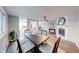 Open dining room featuring wood flooring, brick fireplace, and convenient layout with views of other spaces at 5512 Lunsford Dr, Indianapolis, IN 46237