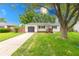 Charming single-story home featuring a well-maintained lawn, attached garage, and inviting front porch at 5512 Lunsford Dr, Indianapolis, IN 46237