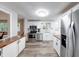 Clean kitchen featuring white cabinets, stainless steel appliances, wood countertop and modern fixtures at 5512 Lunsford Dr, Indianapolis, IN 46237