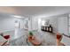 Spacious living area with seamless flow to kitchen, modern decor, and wood-look laminate flooring at 5512 Lunsford Dr, Indianapolis, IN 46237