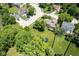Aerial view of a landscaped backyard with mature trees and recreational equipment, nestled in a suburban neighborhood at 5640 Dapple Ct, Indianapolis, IN 46228