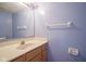 Powder room featuring a sink and a mirror with light-blue walls at 5640 Dapple Ct, Indianapolis, IN 46228